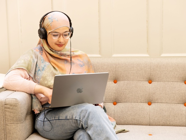 Student with laptop and headphones