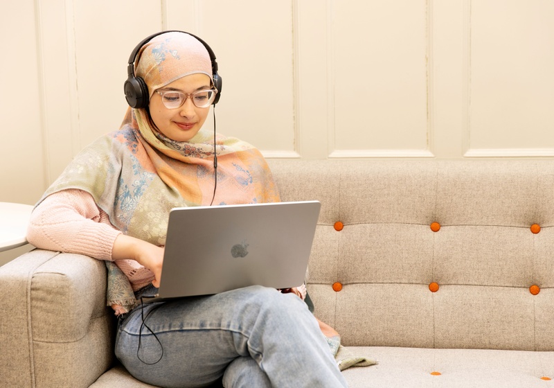 Student with laptop and headphones